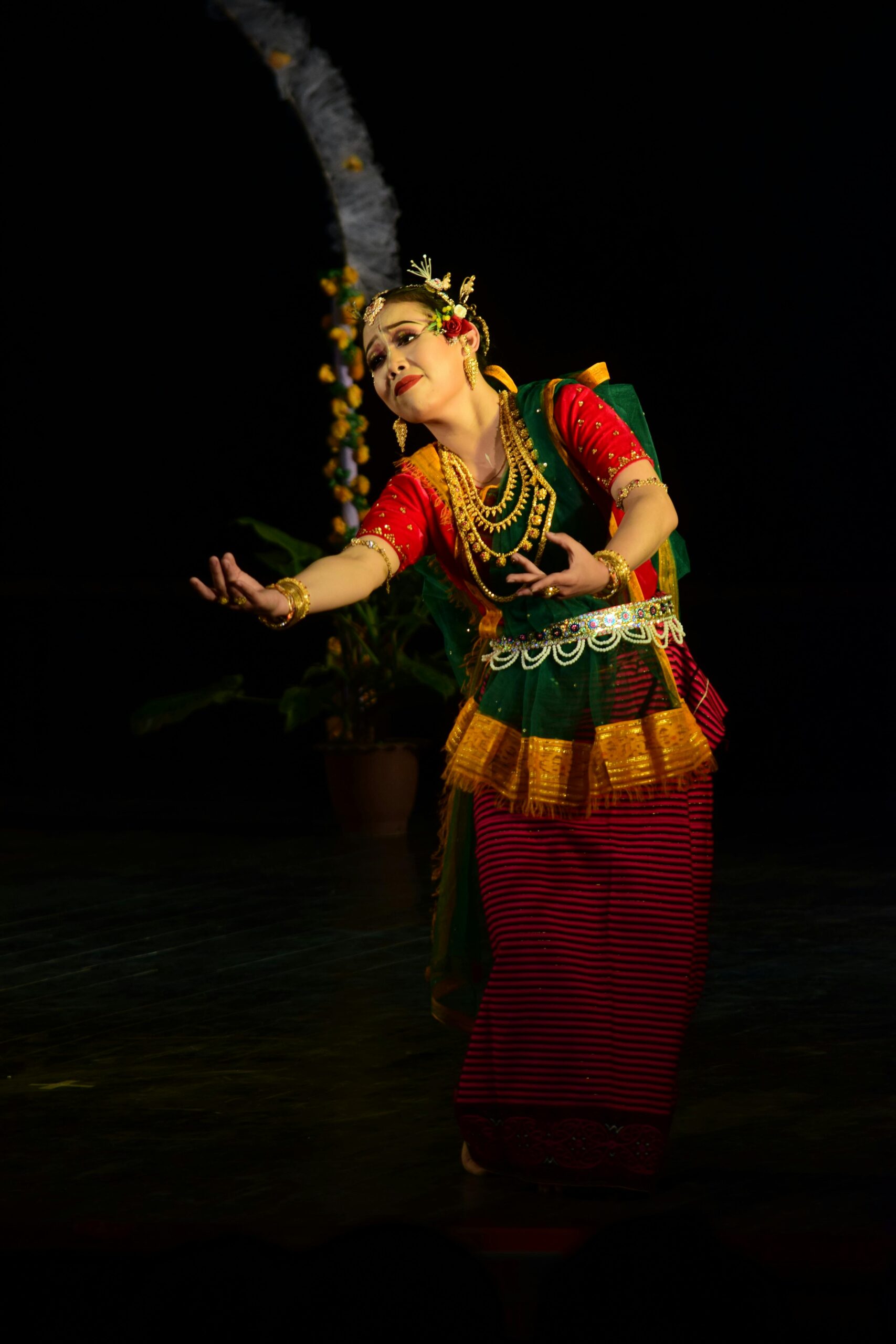 Elegant Indian dancer in traditional attire performing on stage, showcasing cultural heritage.